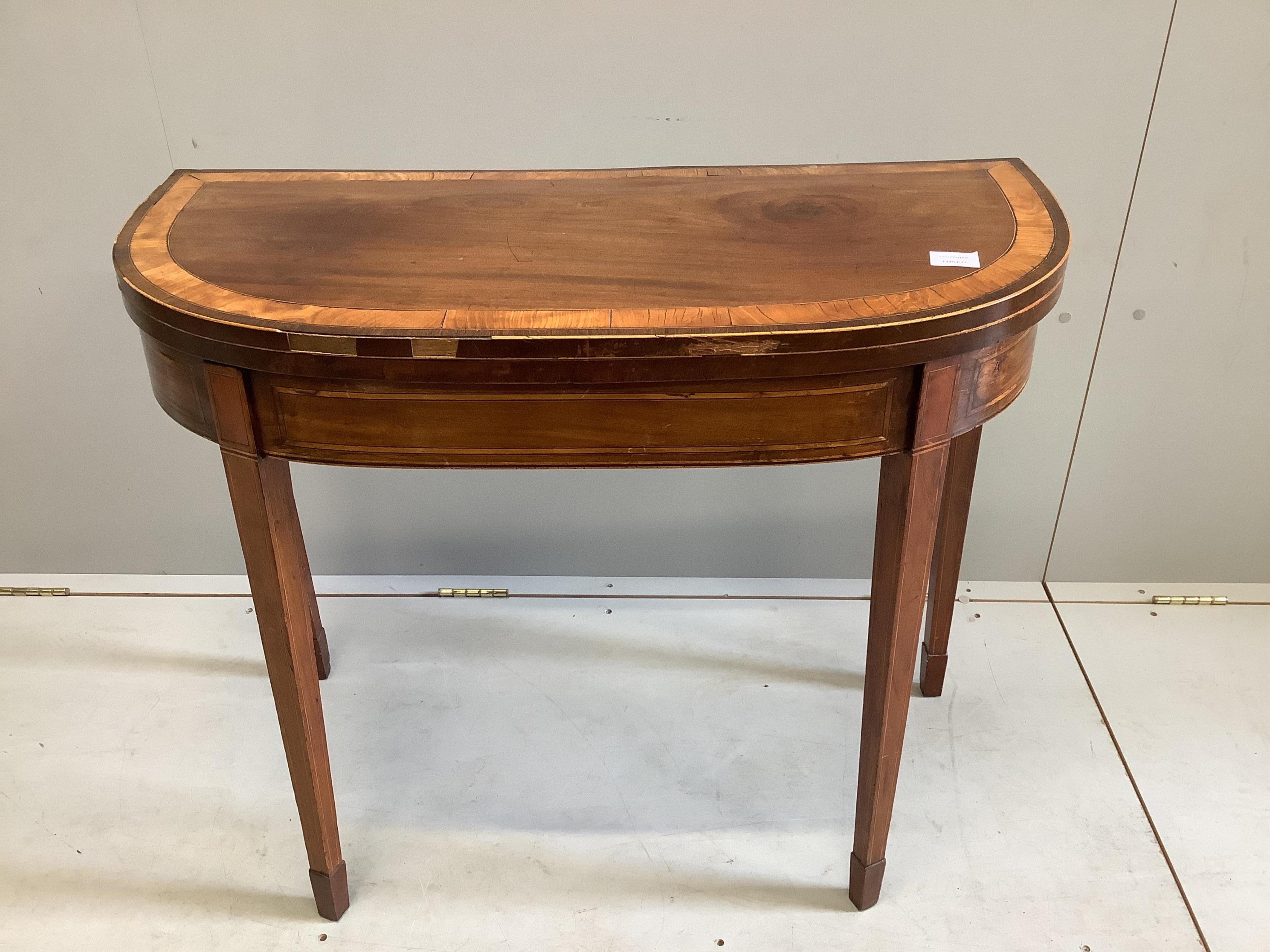 A George III banded mahogany D shape folding card table, width 91cm, depth 43cm, height 74cm. Condition - fair